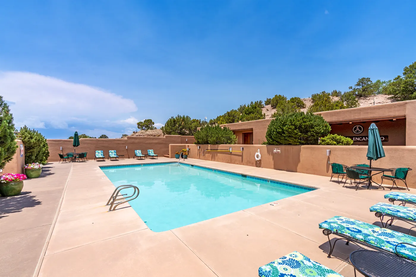 Community pool with Pueblo Encantado clubhouse in the background