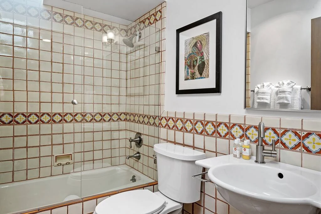 Guest bathroom with Spanish tile shower and tub combo